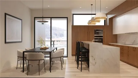 a kitchen with stainless steel appliances kitchen island granite countertop a refrigerator and a stove top oven