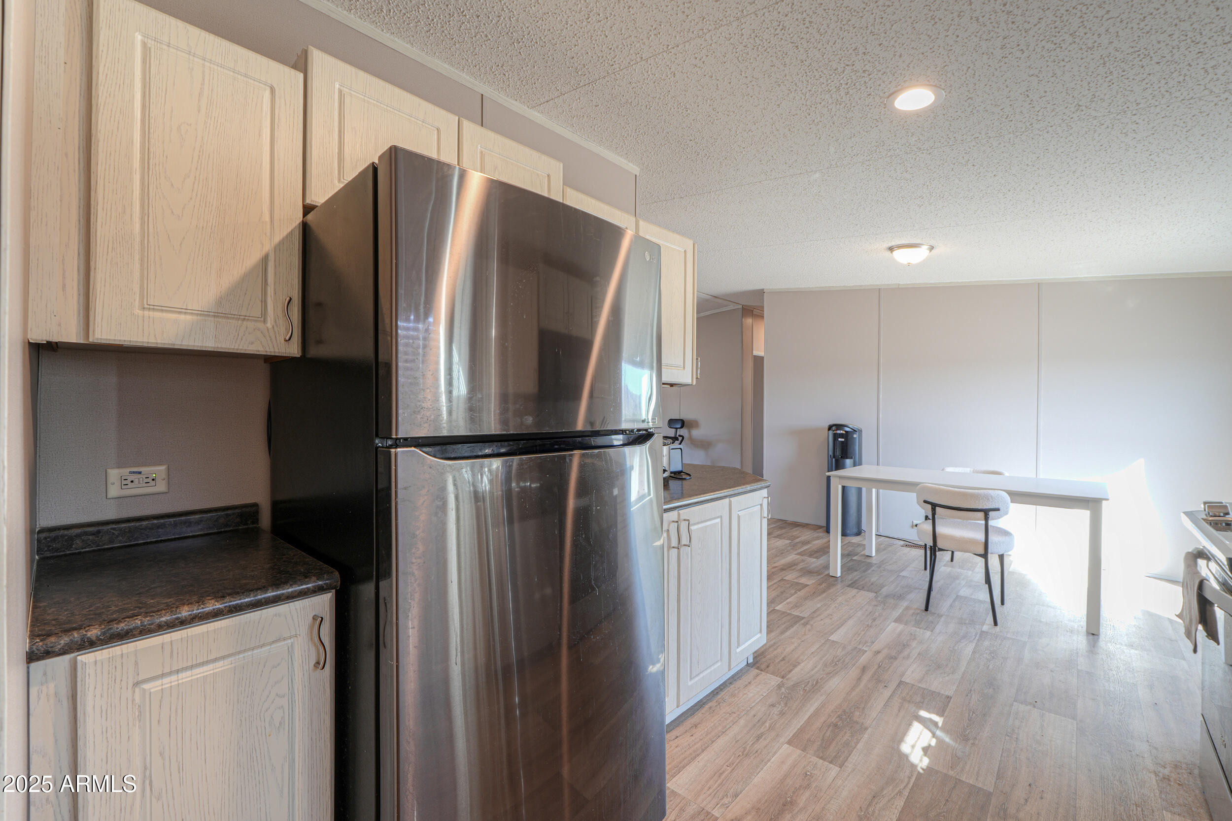11091 North Garduno Road Maricopa, AZ 85139 - Photo 12 of 51 a kitchen with stainless steel appliances a refrigerator and a stove top oven