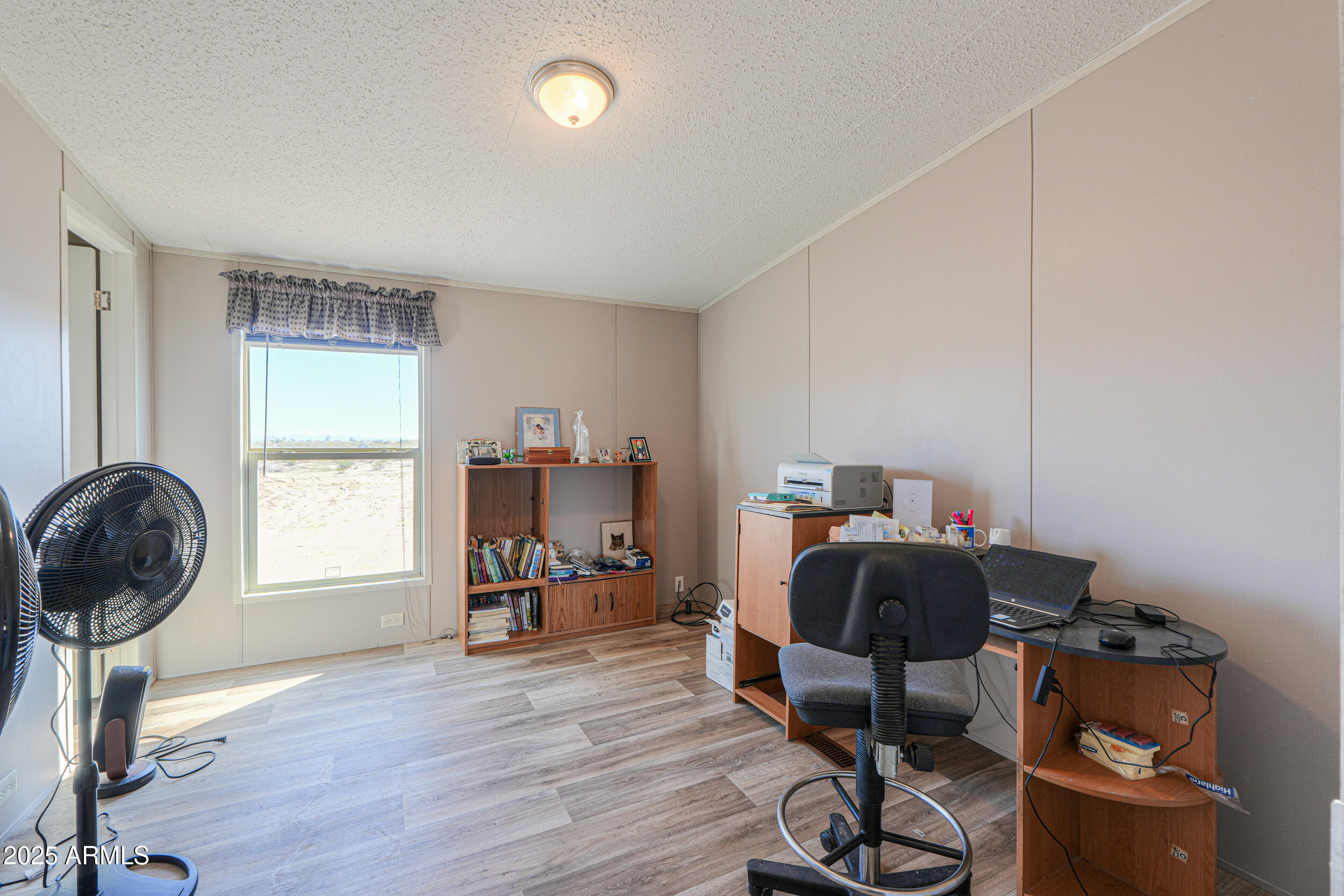 11091 North Garduno Road Maricopa, AZ 85139 - Photo 19 of 51 a view of a workspace with furniture and a window