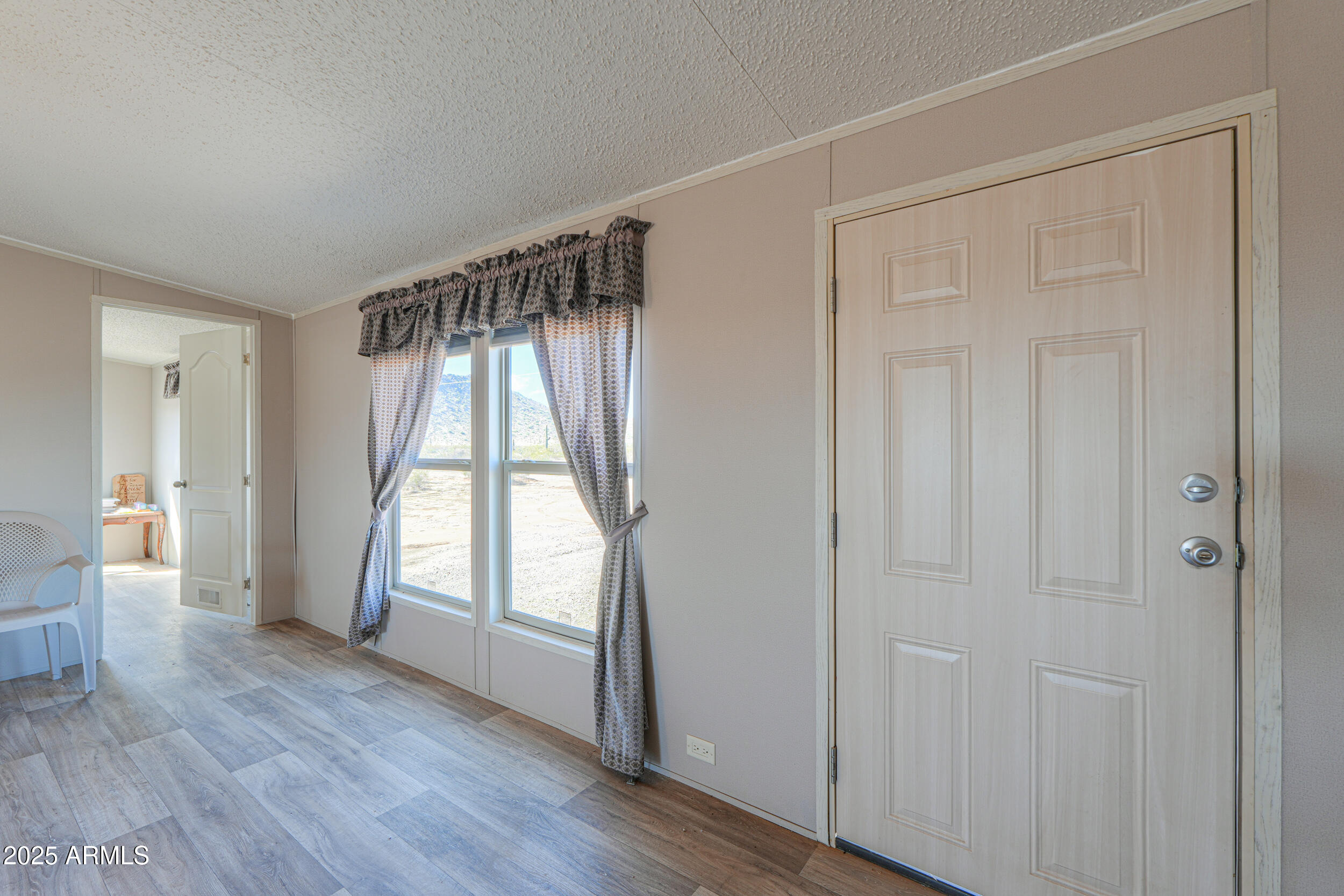 11091 North Garduno Road Maricopa, AZ 85139 - Photo 21 of 51 a view of an empty room with wooden floor and a window