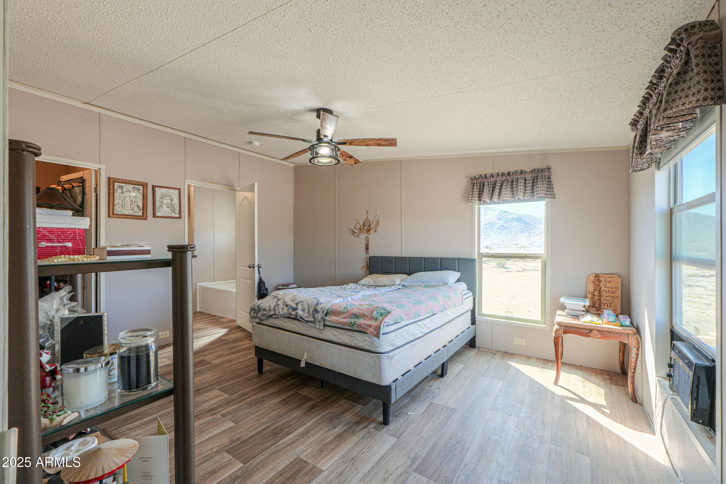 11091 North Garduno Road Maricopa, AZ 85139 - Photo 22 of 51 a bedroom with a bed and wooden floor