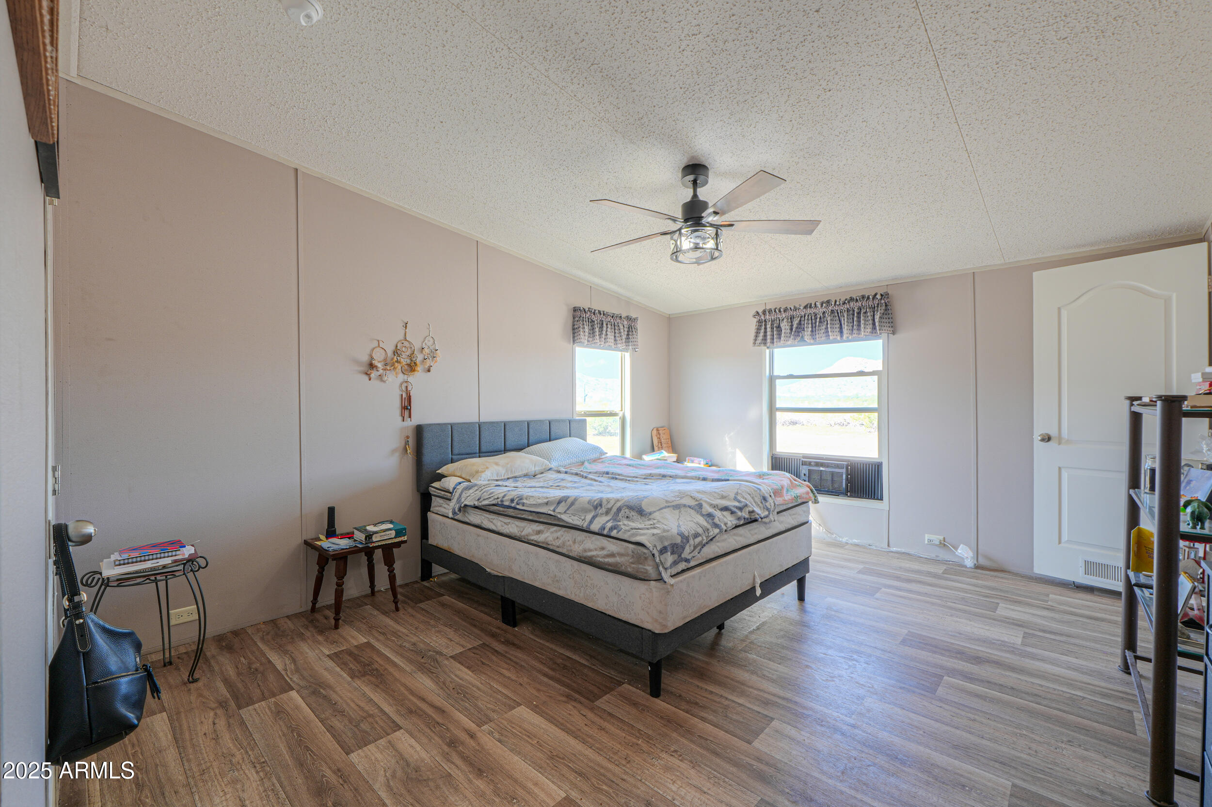 11091 North Garduno Road Maricopa, AZ 85139 - Photo 24 of 51 a spacious bedroom with a bed and a chandelier