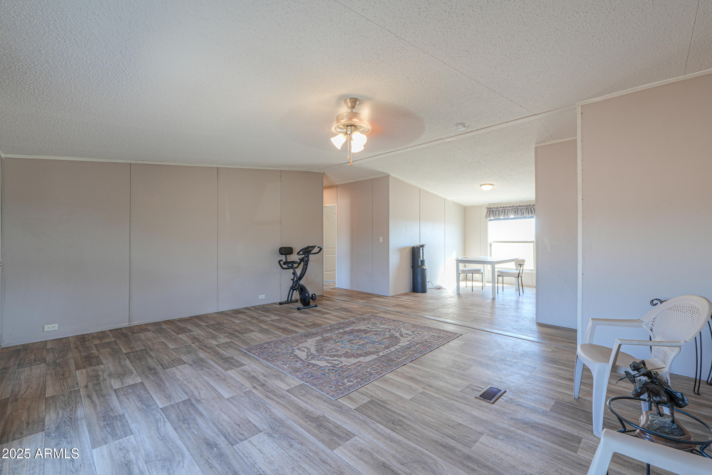 11091 North Garduno Road Maricopa, AZ 85139 - Photo 7 of 51 a view of empty room with wooden floor