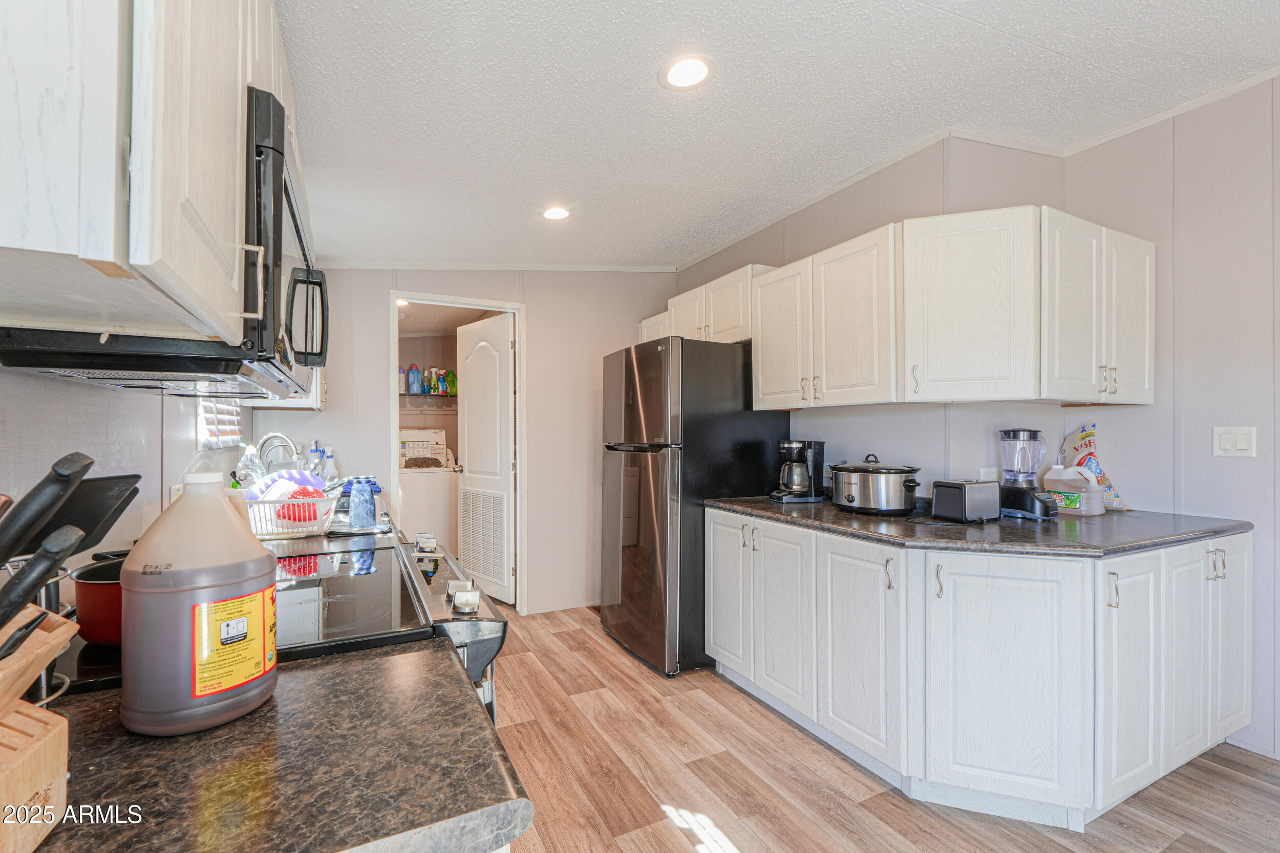 11091 North Garduno Road Maricopa, AZ 85139 - Photo 10 of 51 a kitchen that has a lot of cabinets and appliances