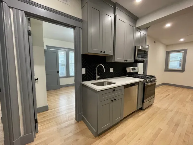 a kitchen that has a sink and a stove in it