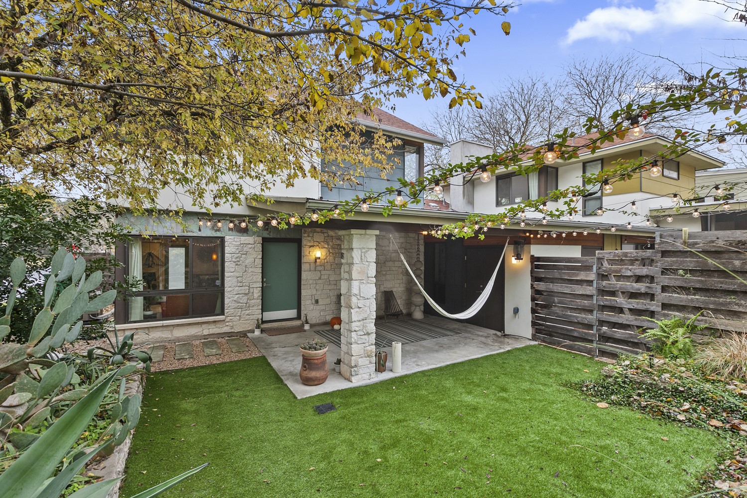The front entry is extremely welcoming and offers a beautiful Astroturf lawn that is green all year round.