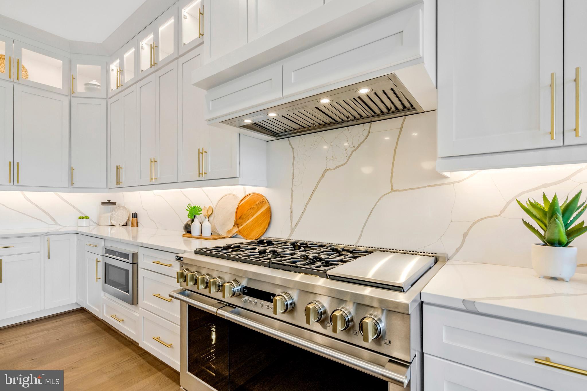 1321 Hunter Mill Road Vienna, VA 22182 - Photo 14 of 92 a kitchen with a stove and white cabinets