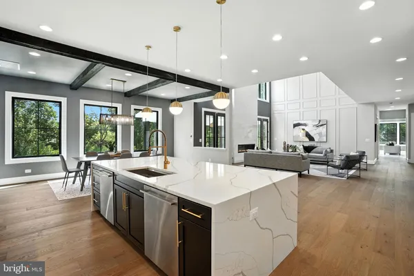 a room with a large window and kitchen view