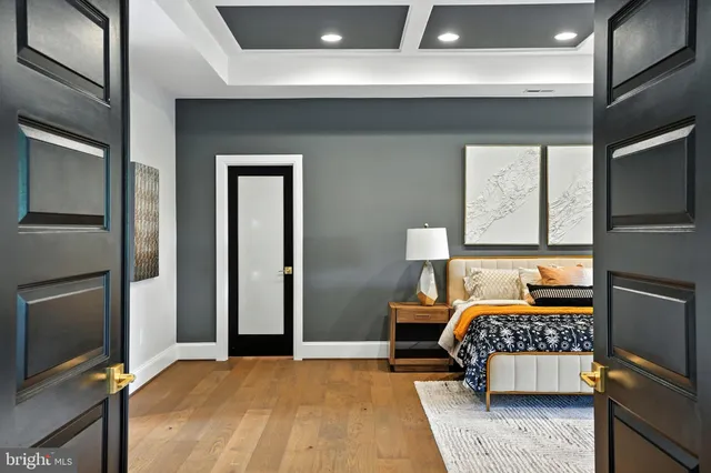 a living room with wooden floor and stairs