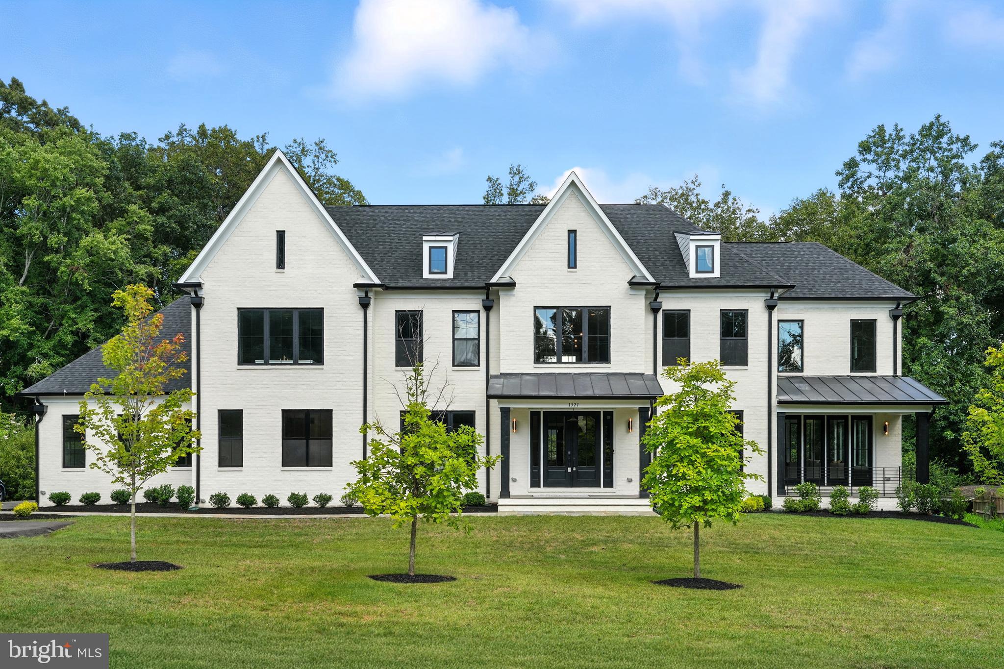 1321 Hunter Mill Road Vienna, VA 22182 - Photo 2 of 92 a front view of a house with a yard