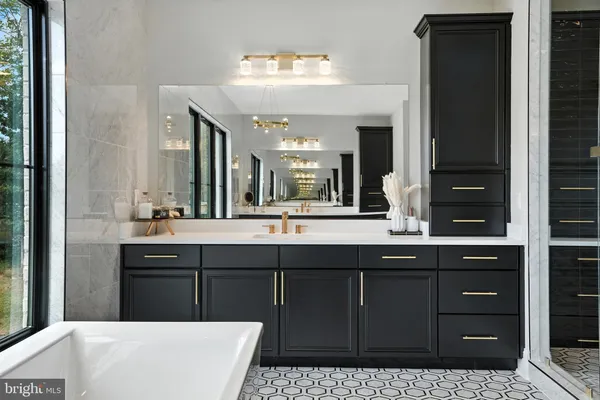 a kitchen with stainless steel appliances granite countertop a sink a stove and a wooden floors