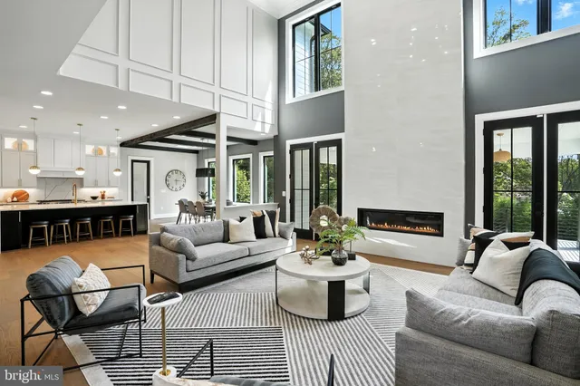 a front view of house with yard and trees in the background