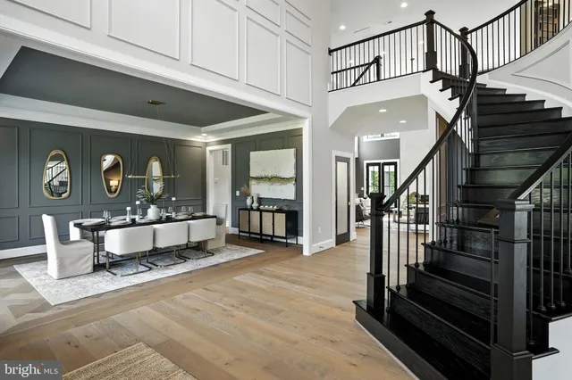 a view of a hallway with wooden floor and a chandelier