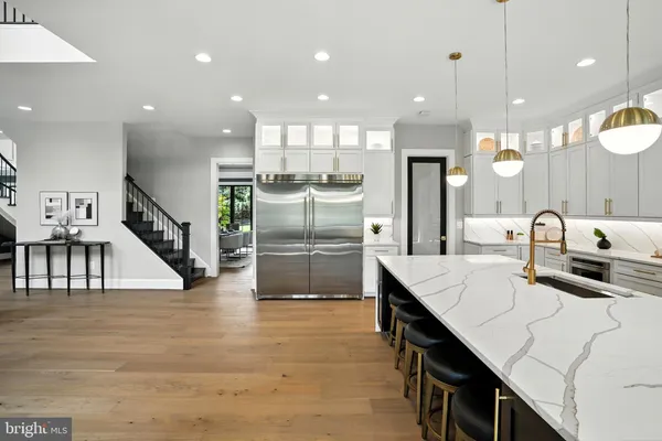 a large kitchen with a table and chairs in it