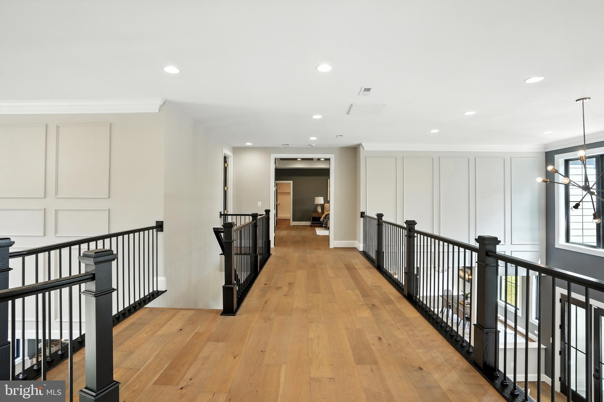 1321 Hunter Mill Road Vienna, VA 22182 - Photo 87 of 92 a view of a hallway with wooden floor and a chandelier