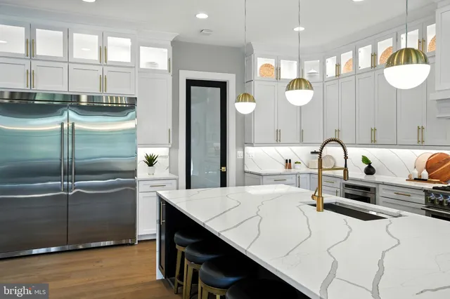 a kitchen with a stove and white cabinets