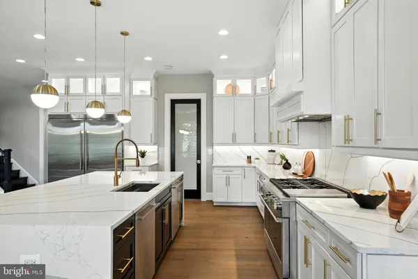 a kitchen with stainless steel appliances granite countertop a sink and a stove