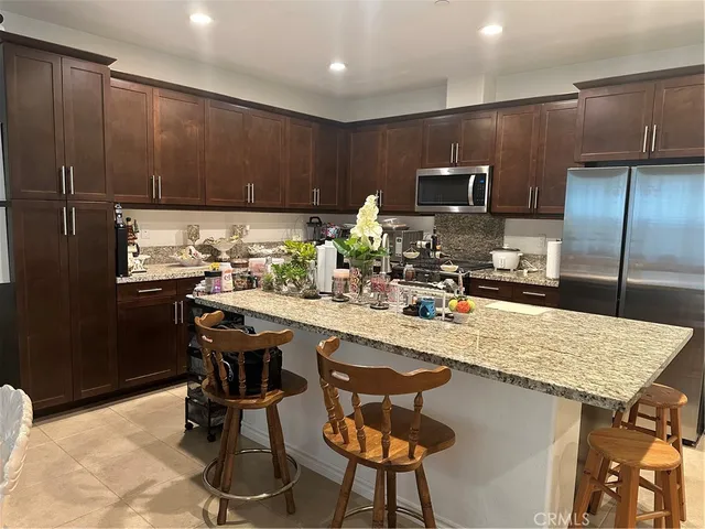 a kitchen with stainless steel appliances granite countertop a sink counter space and cabinets
