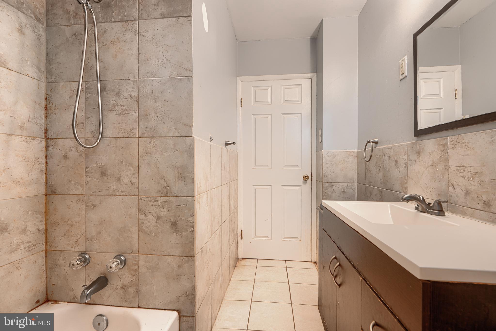 9706 Liberty Road Randallstown, MD 21133 - Photo 31 of 43 a bathroom with a sink and a mirror