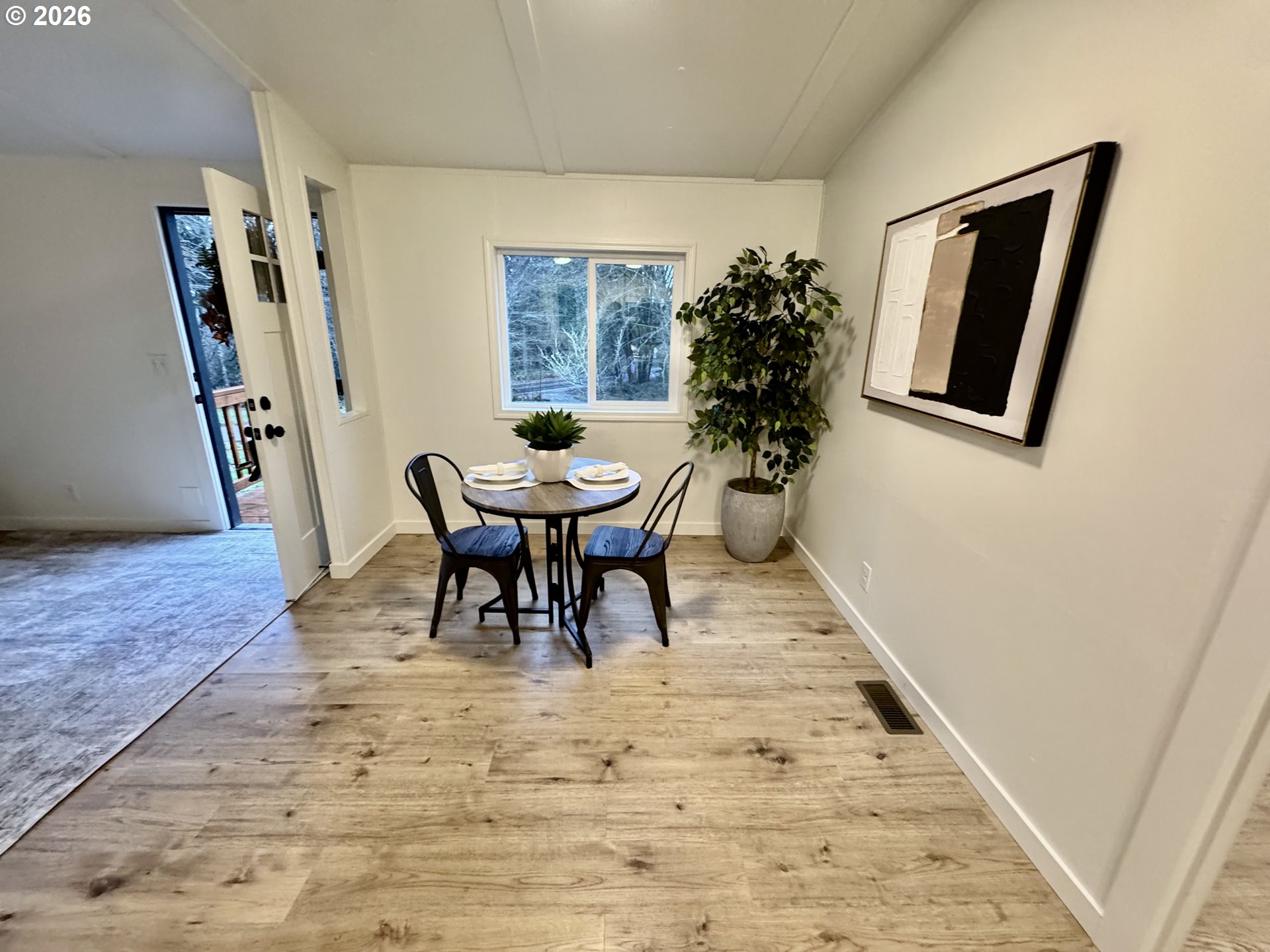 8138 Lewis River Road Ariel, WA 98603 - Photo 15 of 24 a view of a dining room with furniture and a potted plant