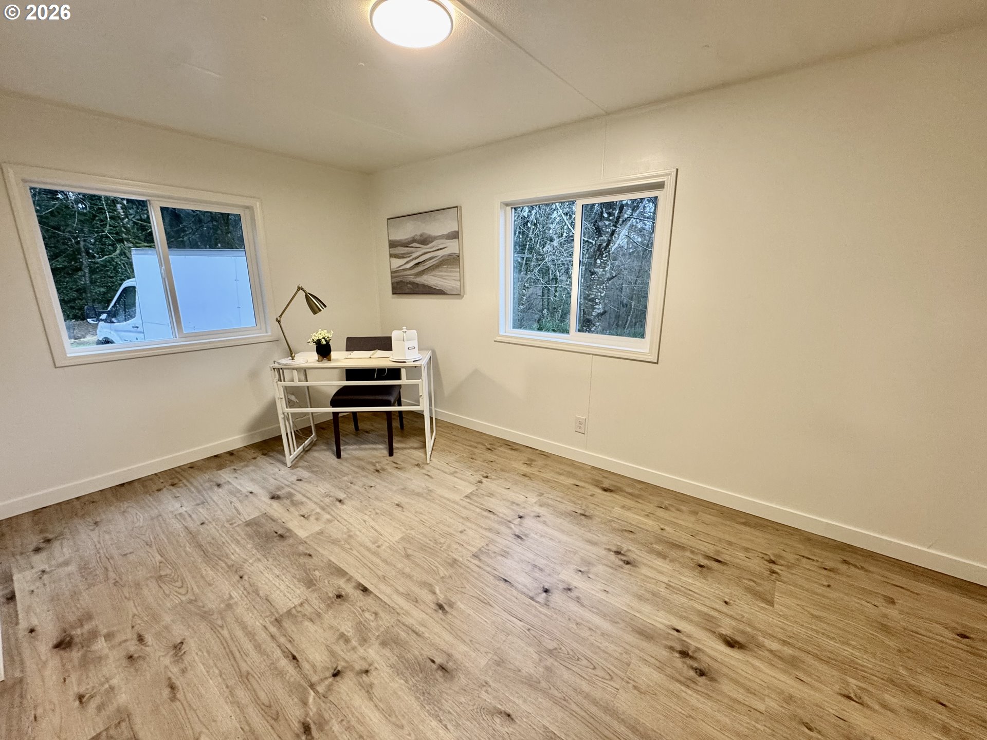 8138 Lewis River Road Ariel, WA 98603 - Photo 22 of 24 a living room with wooden floor and a table