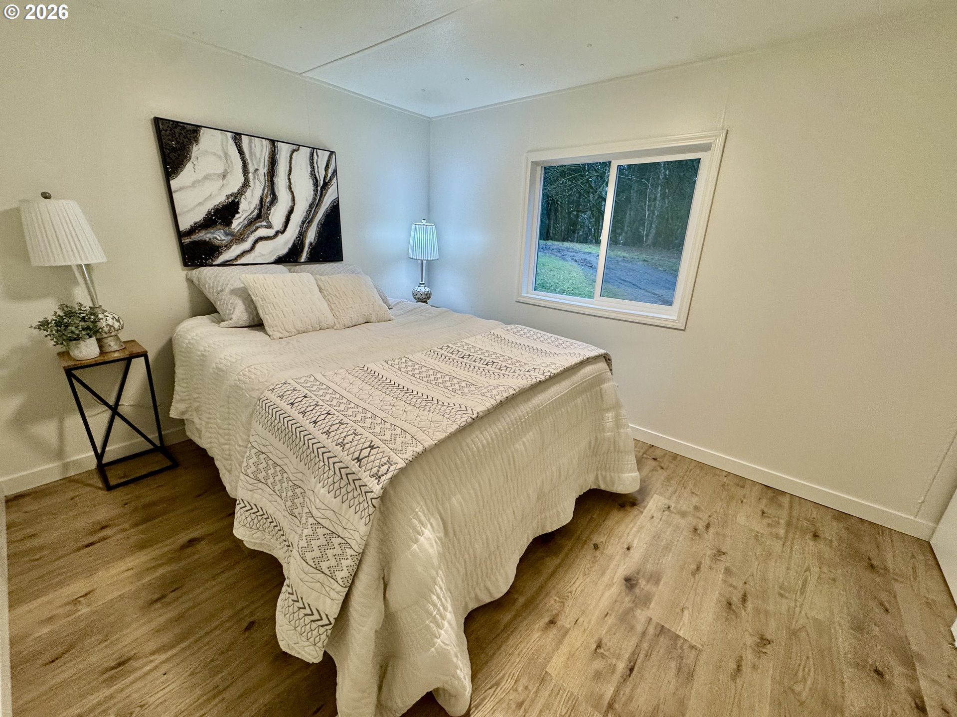 8138 Lewis River Road Ariel, WA 98603 - Photo 23 of 24 a bed sitting in a bedroom next to a window