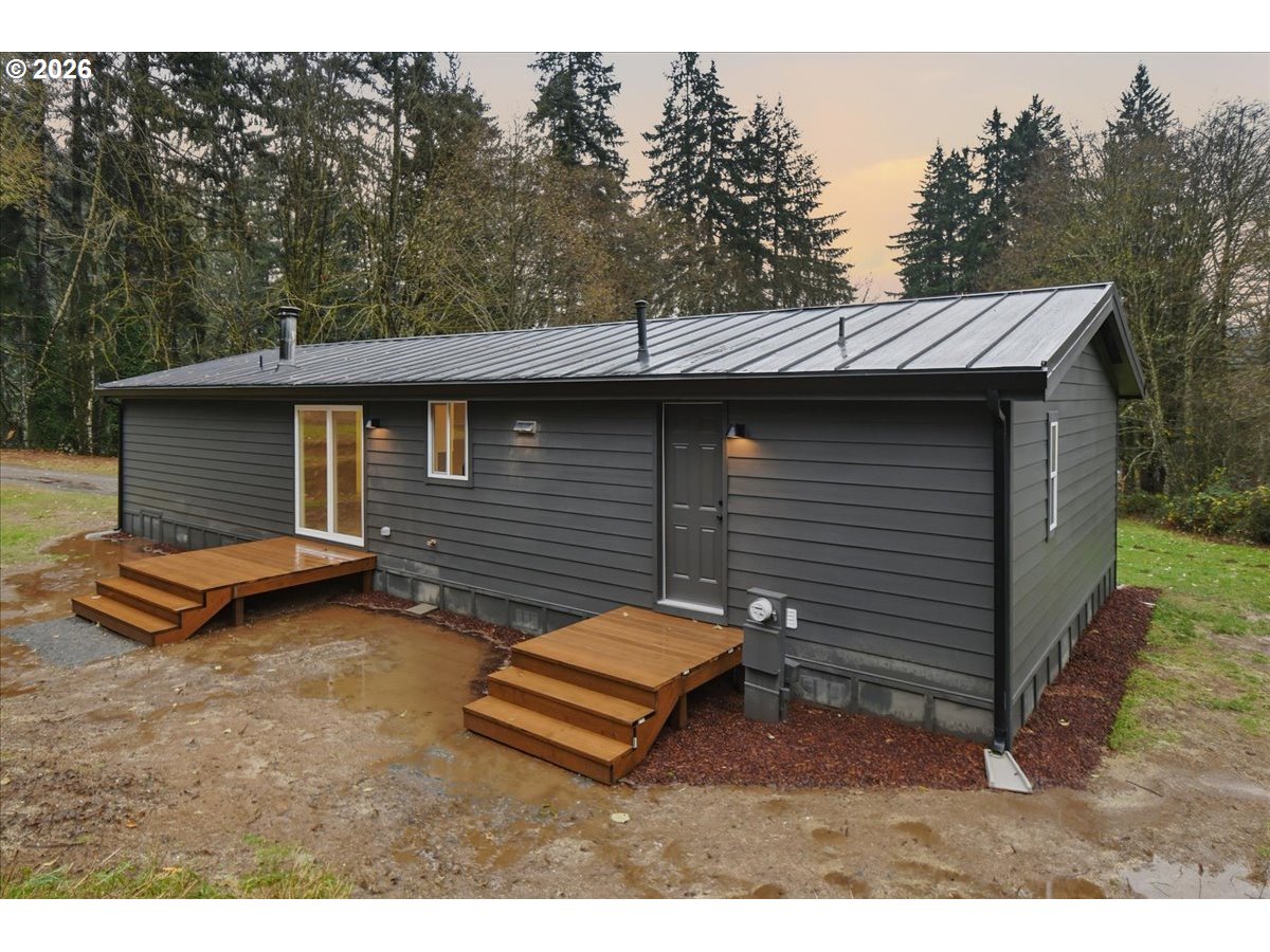 8138 Lewis River Road Ariel, WA 98603 - Photo 5 of 24 a backyard of a house with barbeque oven and trees