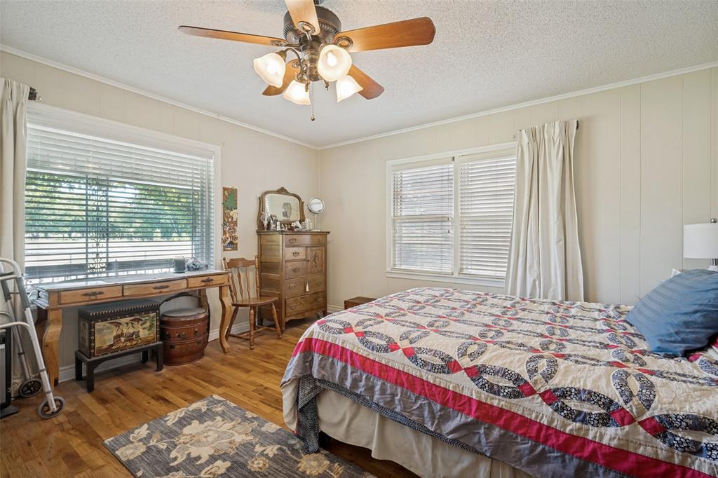 117 County Road Decatur, TX 76234 - Photo 11 of 40 Wood-finish flooring with multiple windows and a ceiling fan