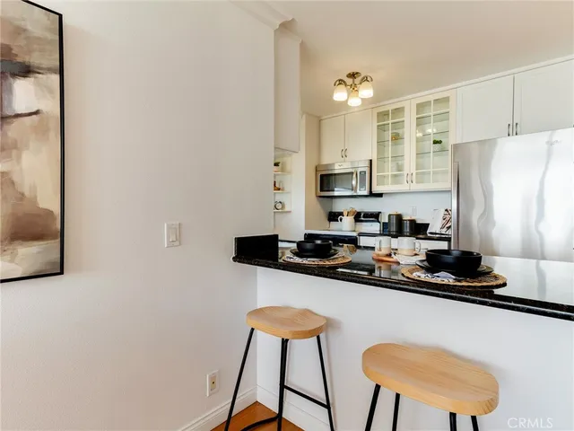 a kitchen with stainless steel appliances granite countertop a refrigerator sink and stove