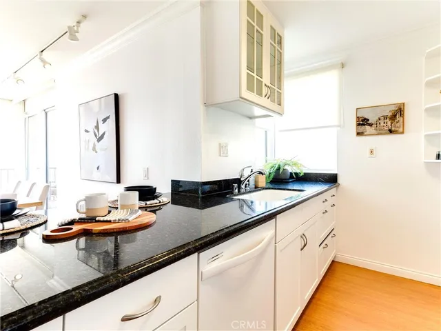 a spacious bedroom with a bed and wooden floor