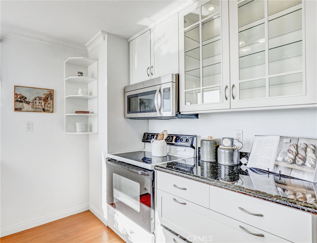 1750 East Ocean Boulevard, Unit 213 Long Beach, CA 90802 - Photo 18 of 52 a kitchen with stainless steel appliances granite countertop a sink and a microwave