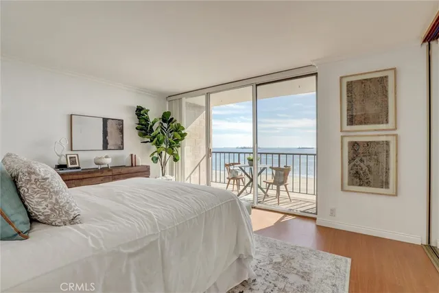 a bedroom with a bed and a lamp on dresser