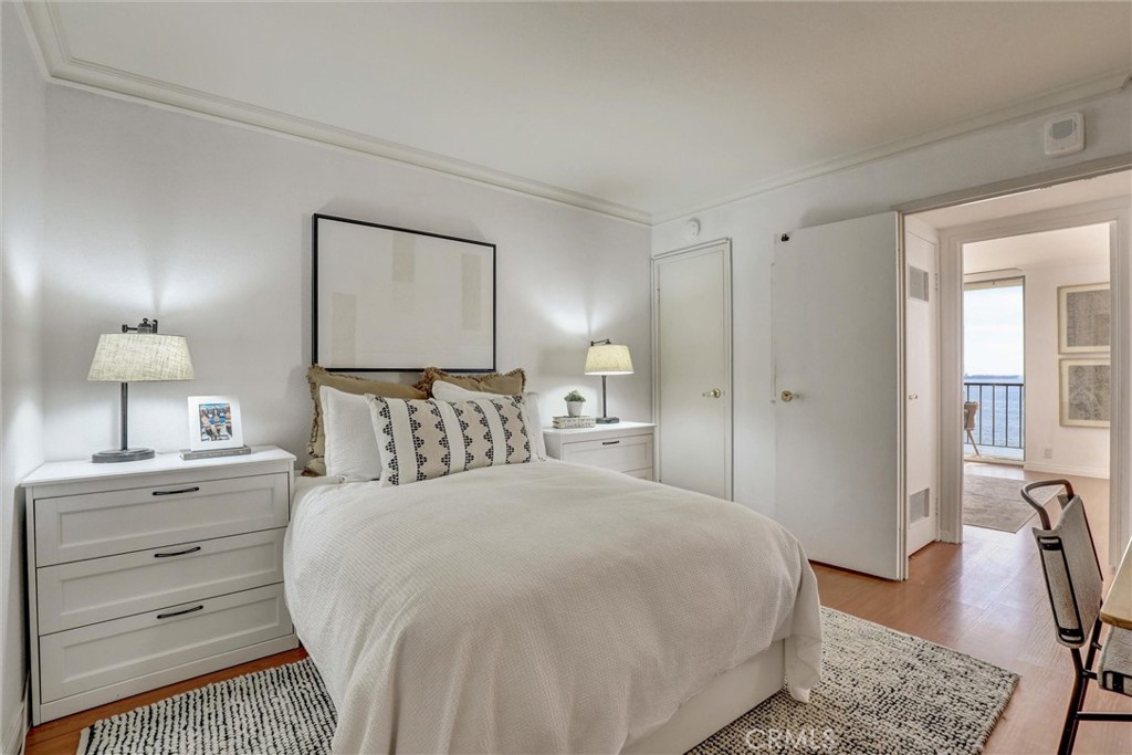 1750 East Ocean Boulevard, Unit 213 Long Beach, CA 90802 - Photo 31 of 52 a bedroom with a bed and a lamp on dresser