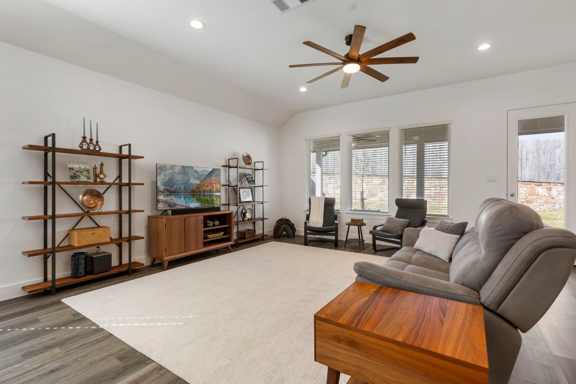 13757 Rising Sun Lane Conroe, TX 77384 - Photo 13 of 39 a living room with furniture a ceiling fan and a window