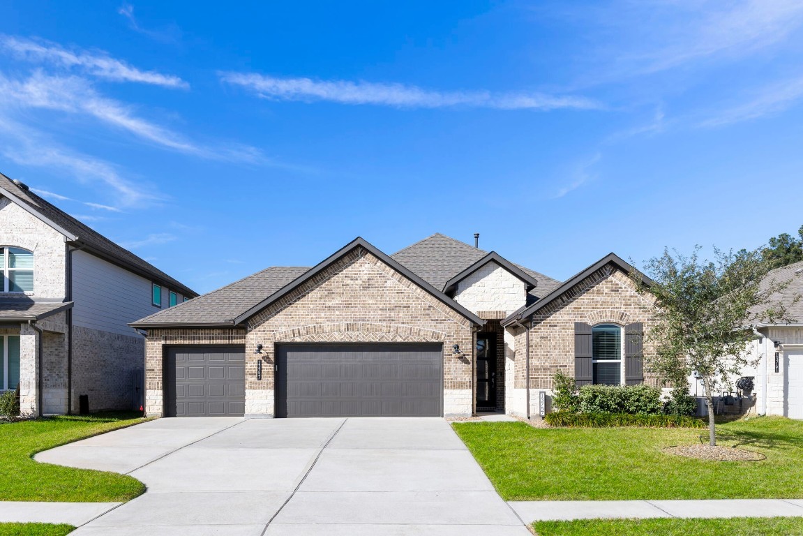 13757 Rising Sun Lane Conroe, TX 77384 - Photo 2 of 39 a front view of a house with yard and garage