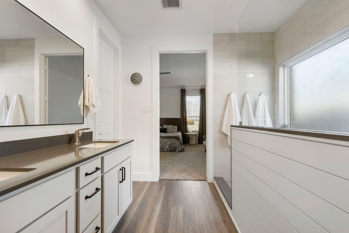 13757 Rising Sun Lane Conroe, TX 77384 - Photo 21 of 39 a kitchen with a sink and a wooden floor