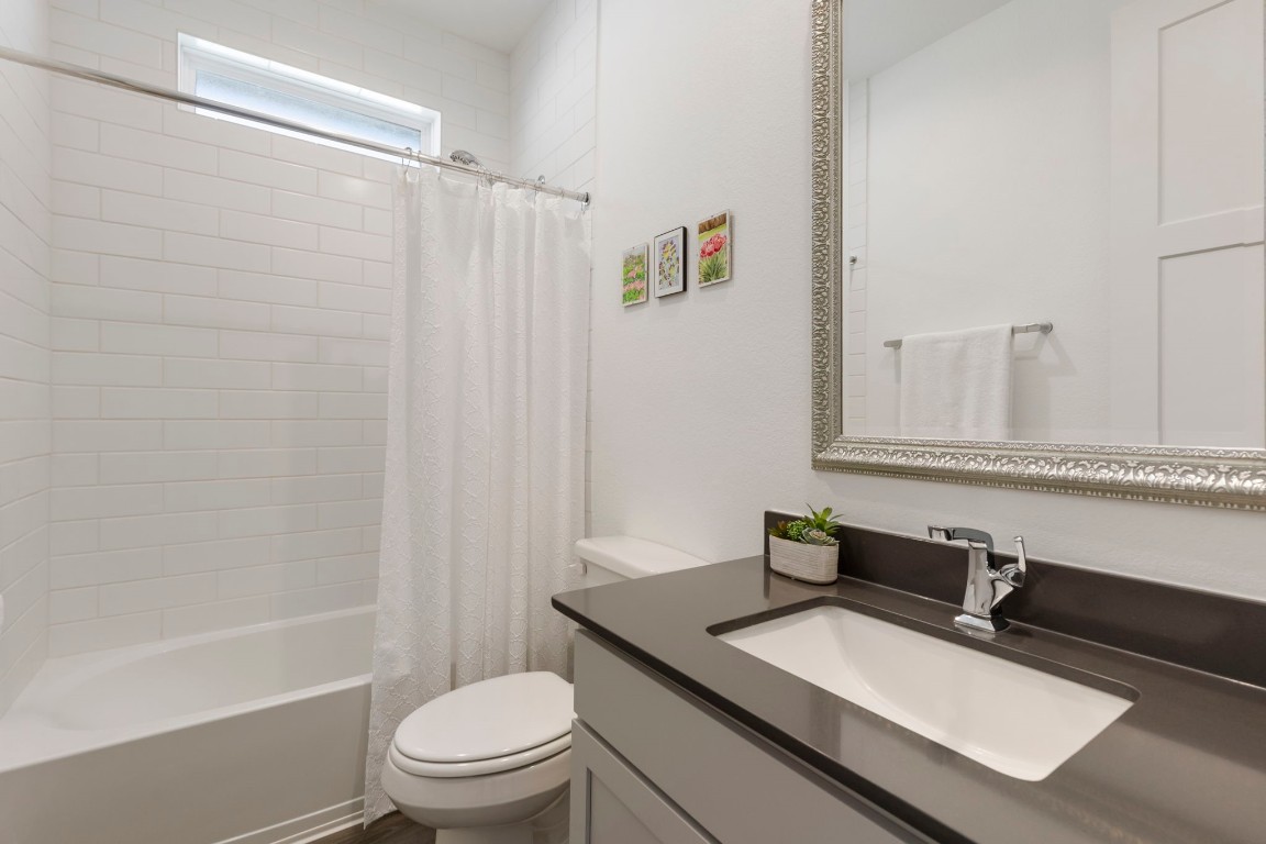 13757 Rising Sun Lane Conroe, TX 77384 - Photo 25 of 39 a bathroom with a sink a toilet and a bathtub