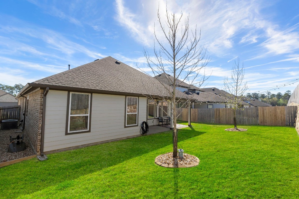 13757 Rising Sun Lane Conroe, TX 77384 - Photo 32 of 39 a backyard of a house with a table and chair