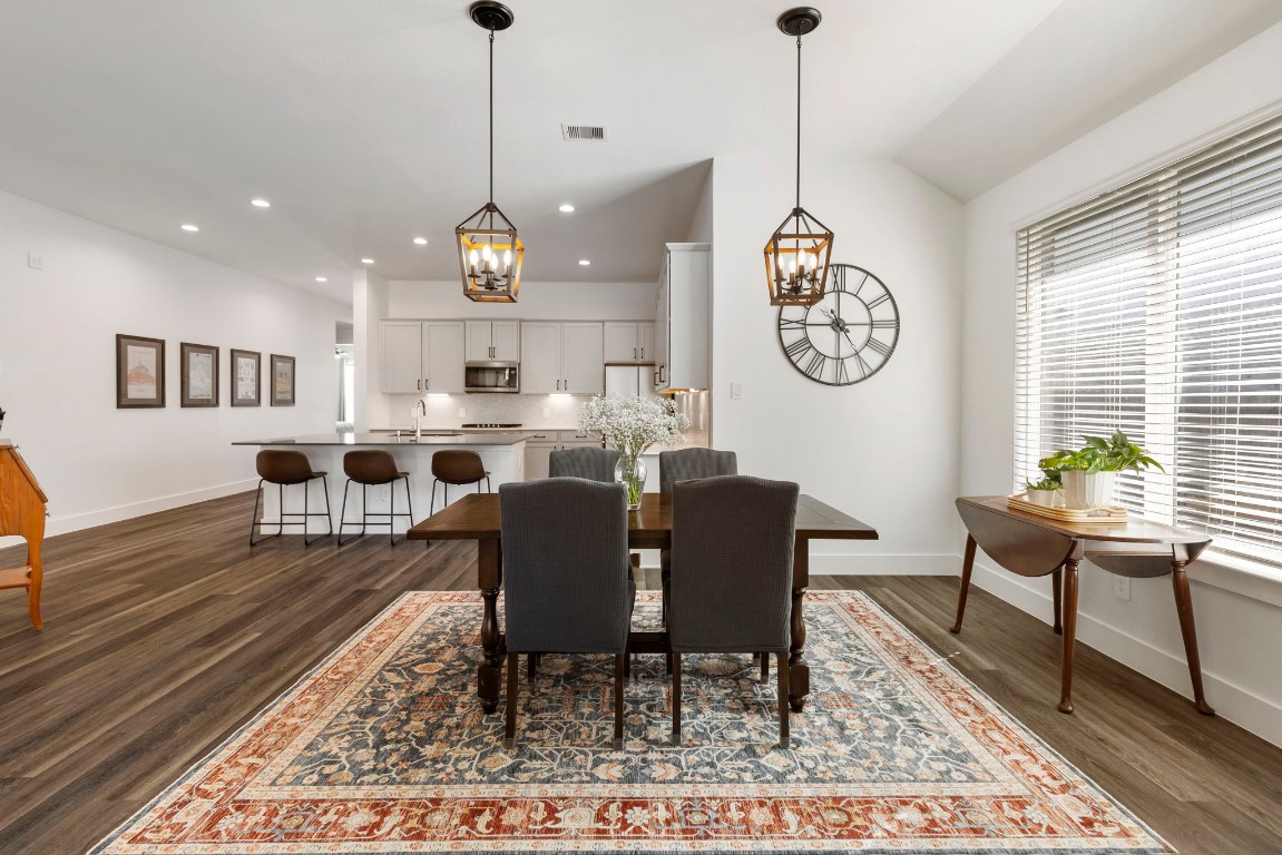 13757 Rising Sun Lane Conroe, TX 77384 - Photo 10 of 39 a dining room with furniture a rug and a chandelier