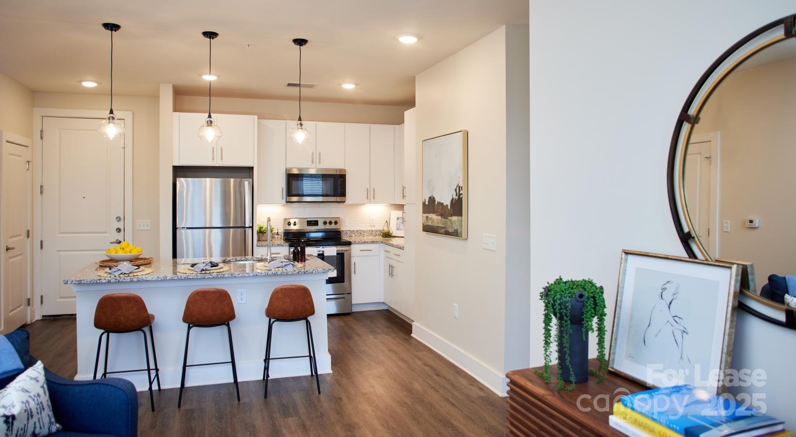 4101 Glenloch Circle, Unit A2 Matthews, NC 28105 - Photo 23 of 28 a kitchen with furniture and a wooden floor