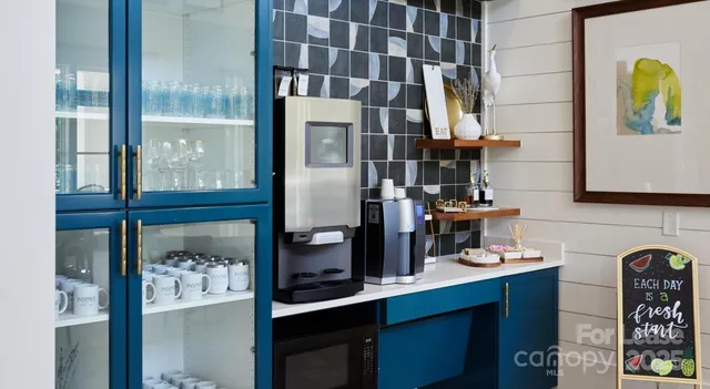 a kitchen with stainless steel appliances granite countertop a refrigerator and a stove