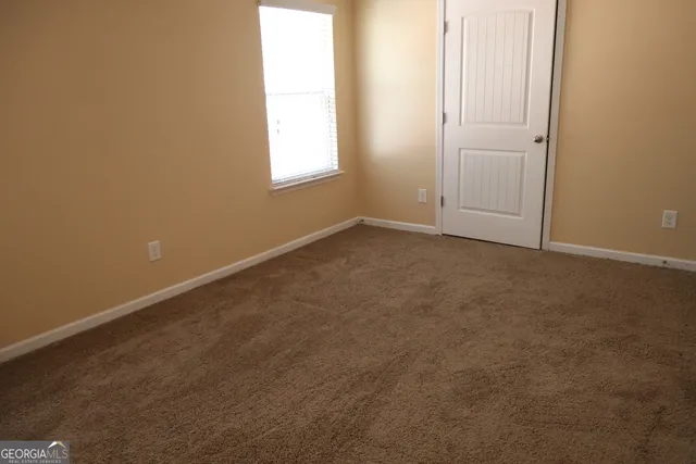 a view of backyard with green space and wooden fence