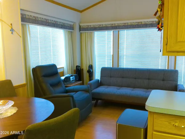 a kitchen with a sink a counter top space and living room