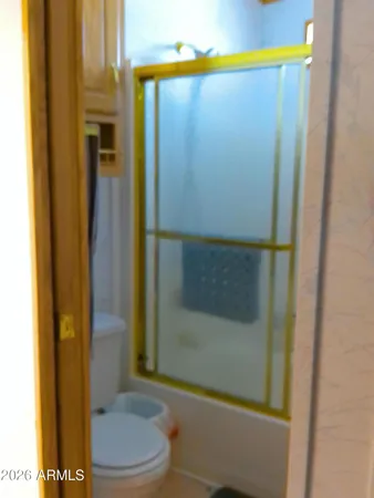 a view of a room with two windows and a cabinet