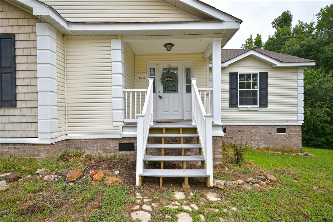 579 Daventon Road Honea Path, SC 29654 - Photo 34 of 44 A welcoming front entrance features sturdy steps leading to a classic porch, ready for outdoor enjoyment.