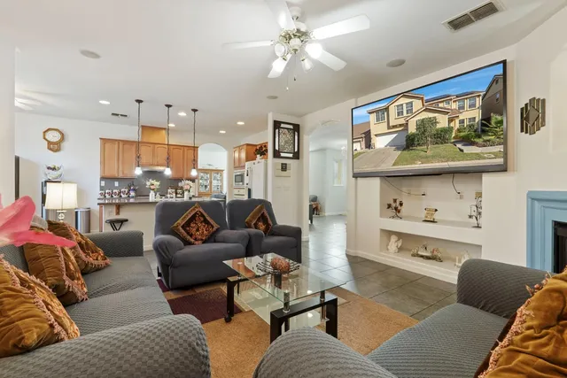 a view of a hallway with stairs and a chandelier fan