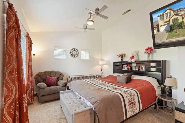 a spacious bedroom with a bed and a painting on the wall