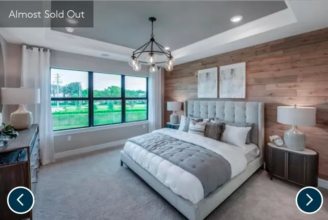 a bedroom with a bed and a chandelier