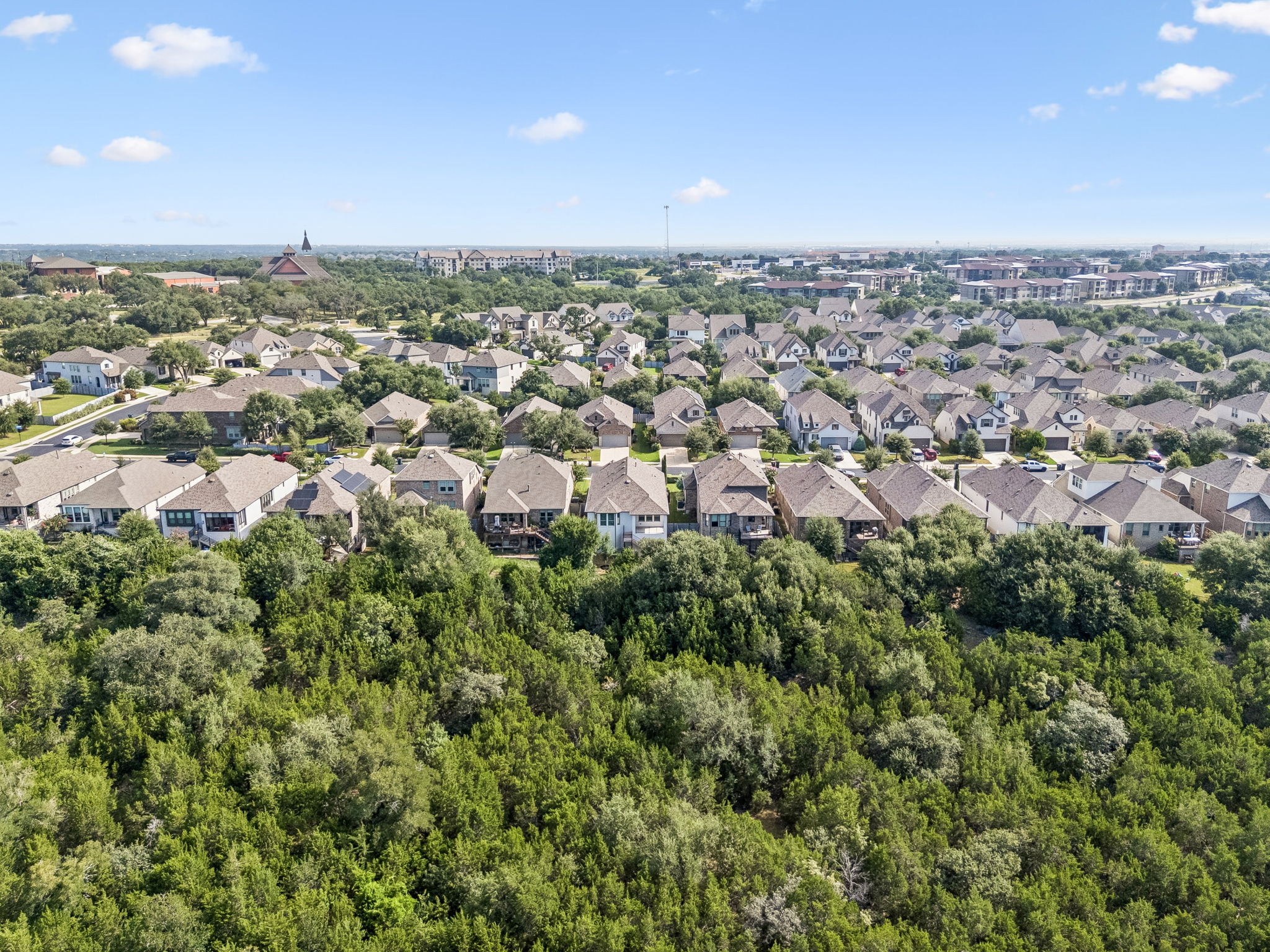 228 Arrowhead Mound Road Georgetown, TX 78628 - Photo 27 of 34 An aerial perspective reveals a harmonious community nestled amidst abundant, mature trees and natural surroundings.