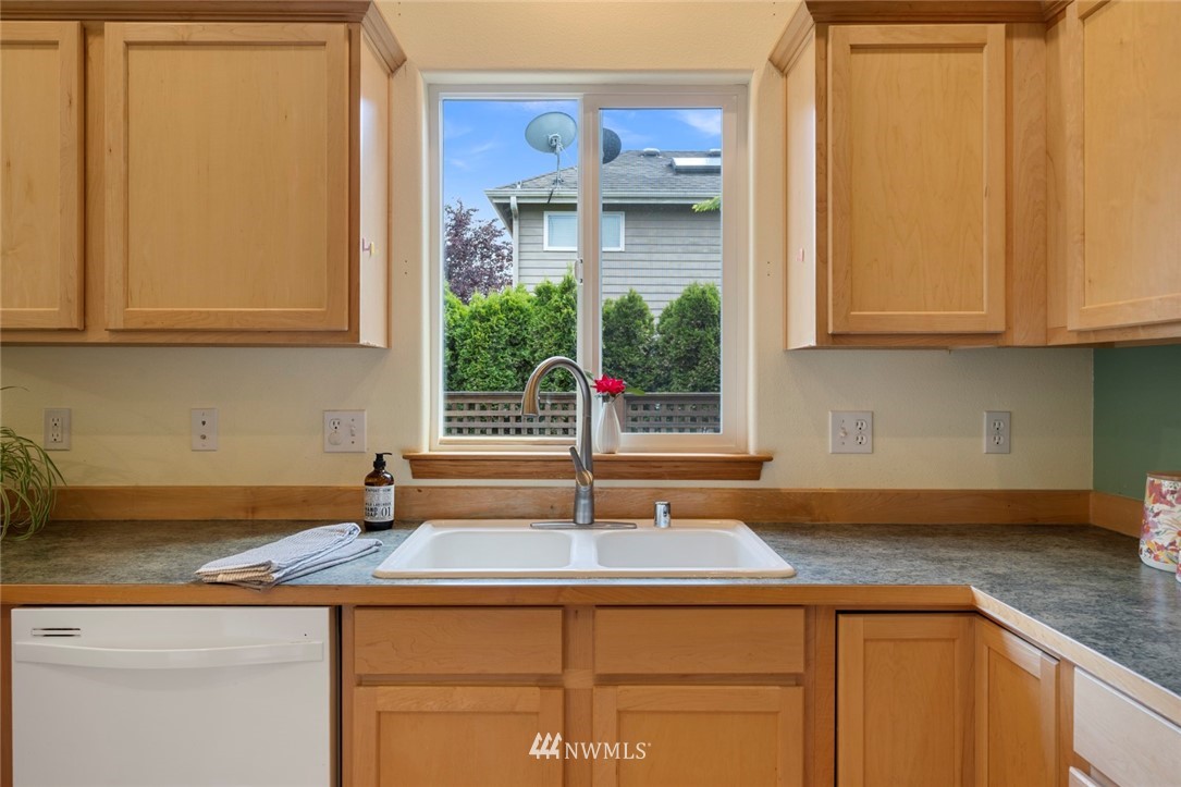 3530 186th Place Southeast Bothell, WA 98012 - Photo 12 of 38 a kitchen with stainless steel appliances granite countertop a sink and a white cabinets